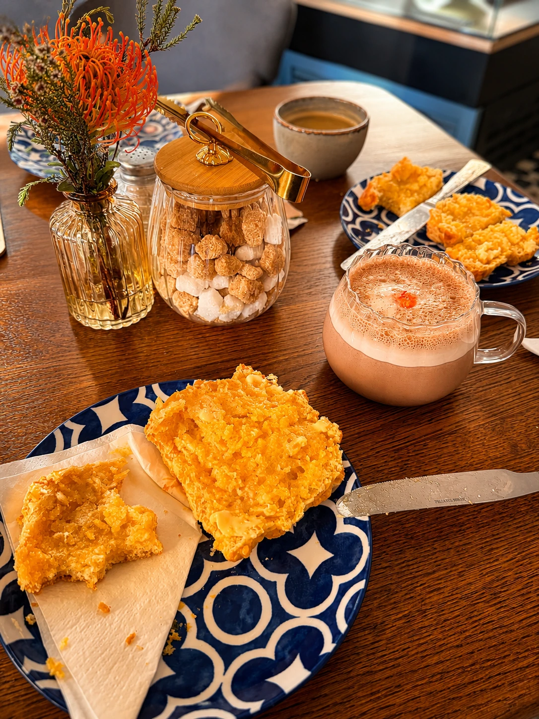 Coffee, tea, cake and biscuits arranged on a café table