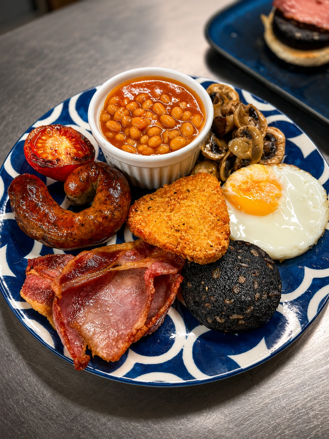 A full breakfast served on a blue patterned plate