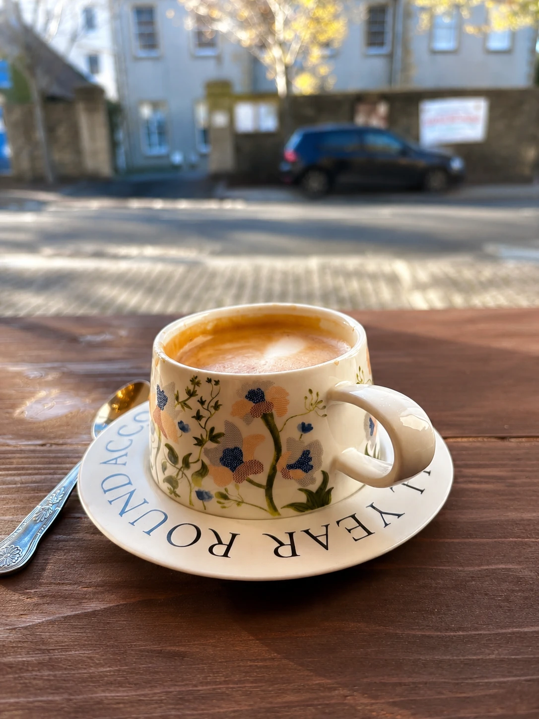Coffee in a floral cup by the front window